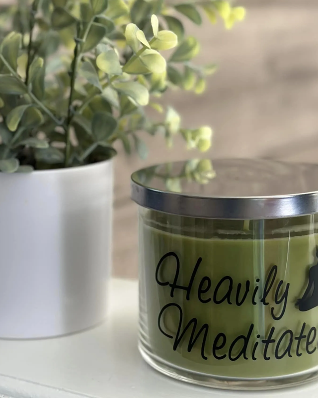 Huntington 3-Wick Heavily Meditated Candle with Silver Lid, Meditation Silhouette, and Flower Decoration on Wooden Background